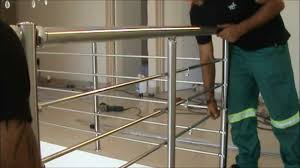 Skilled professionals installing a modern railing on a balcony.