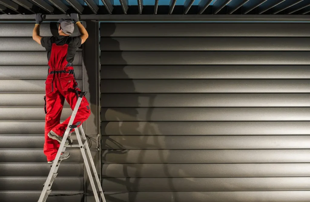 A professional technician repairing a roller shutter with precision tools.